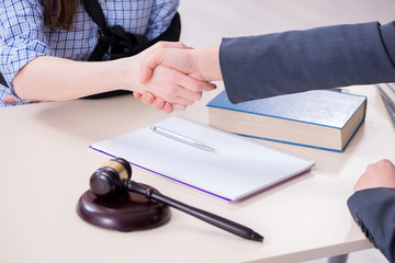Injured employee visiting lawyer for advice on insurance