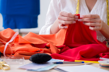 Obraz premium Woman tailor working on new dress designs