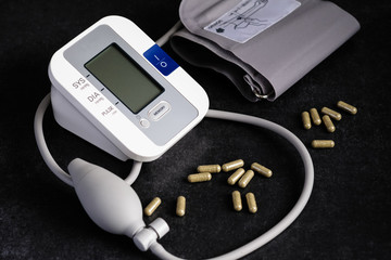 Tonometer for measuring blood pressure on a dark background with biologically active food additives