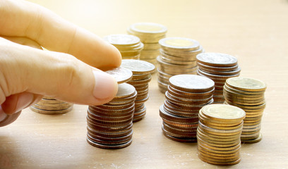 Hand use Coins of thailand with investment and saving for financial investment concept