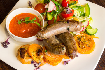Fried sausages and salad