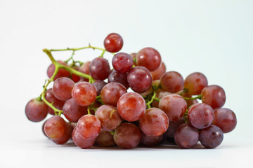 Red grapes on white background.