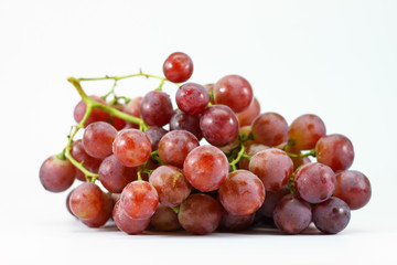 Red grapes on white background.