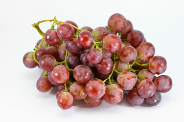 Red grapes on white background.