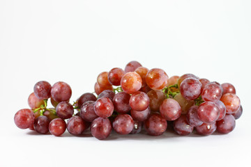 Red grapes on white background.