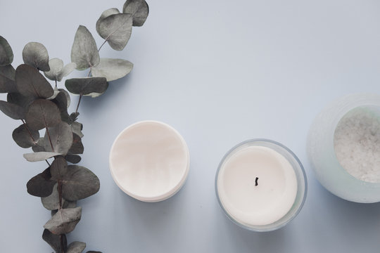 Woman Spa Beauty Products On Pastel Blue Backround From Above. Body, Face, Hair Sugar Salt Scrub, Candle, Eucalyptus. Minimalism Blogger Concept