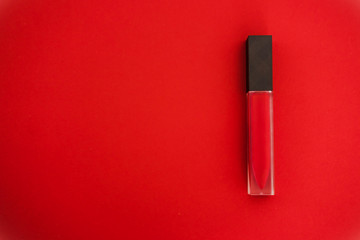 Red matte liquid lipgloss on the same bold vivid colored background. Copyspace