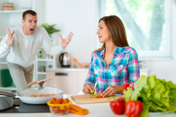 Obraz na płótnie Canvas Couple In Kitchen Conflict