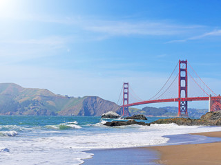 View of Baker beach in San Francisco seeing landmark red Golden Gate Bridge and Marin Headlands in...