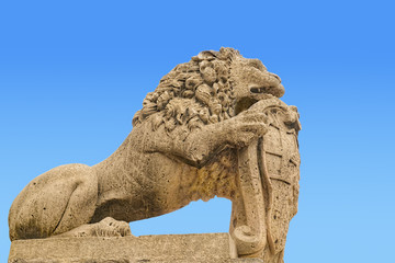Fototapeta na wymiar Medieval Maltese sculpture of lion, isolated on blue