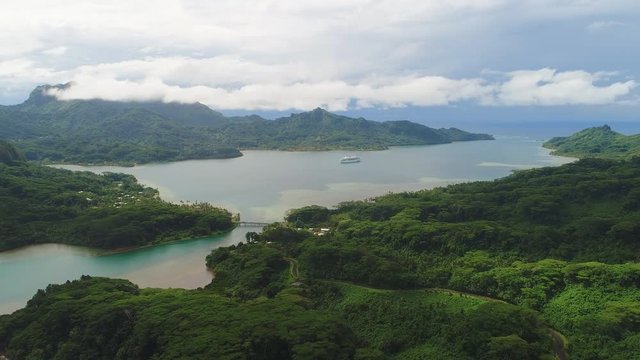 Aerial panoramic view of tropical paradise of Huahine island, Maroe Bay, slopes of hills covered in lush green rain forest - South Pacific Ocean, panorama landscape of French Polynesia from above
