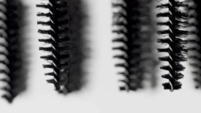 mascara brushes macro on white moving many brashes