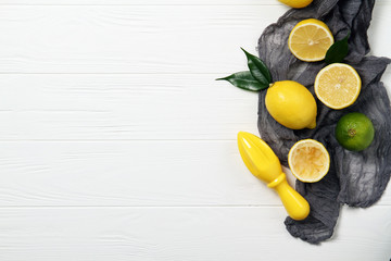 Lemons and a juicer on a white table