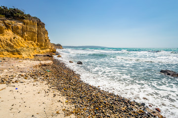 Beach, Greece - Kos Island, Kefalos: Picturesque deep blue Caribbean Bay with wild sea of ​​Greek Agais and steep sandstone cliffs, perfect for wind surfers with heavy waves