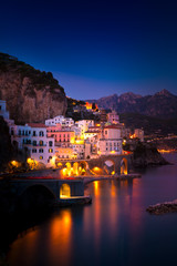 Naklejka na ściany i meble Night view of Amalfi cityscape on coast line of mediterranean sea, Italy