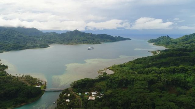 Aerial panoramic view of tropical paradise of Huahine island, Maroe Bay, slopes of hills covered in lush green rain forest - South Pacific Ocean, panorama landscape of French Polynesia from above