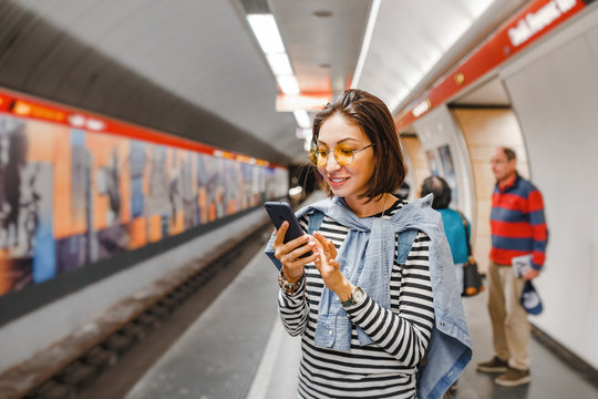 Woman using her smartphone application to know about public transport schedule