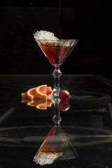 Orange cocktail on black background