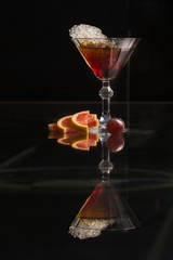 Orange cocktail on black background