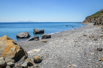 kos island secluded beach near thermal springs, with some peddles magical blue water of the aegean...