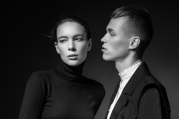 Young couple posing on dark background
