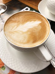 Delicious cappuccino coffee in a blue mug 