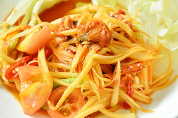 Som tum Thai spicy green papaya with pickled mussel salad on dish