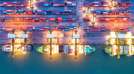 Container ship in export and import business and logistics. Shipping cargo to harbor by crane. Water transport International. Aerial view and top view.