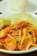 Som tum Thai spicy green papaya with pickled mussel salad eat couple sticky rice on plate