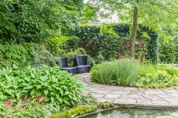 Gordijnen Garden design with water element and rounded patway © HildaWeges