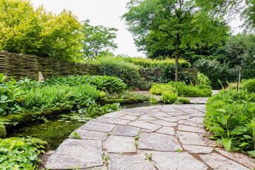 Garden design with water element and rounded flagstones