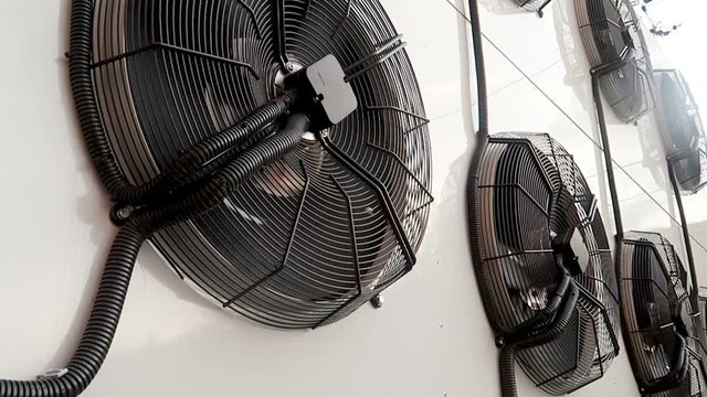 Air conditioner unit fan rotating. Rotating large industrial fans.