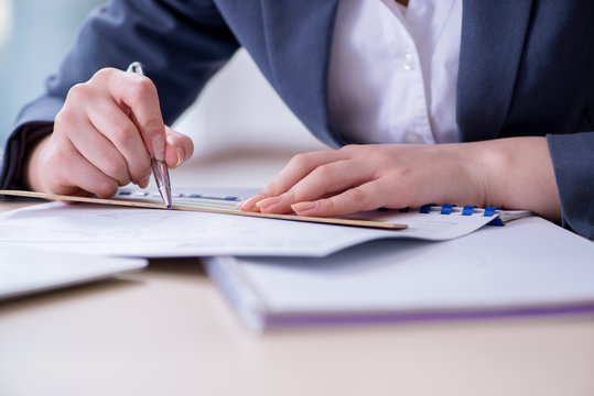 Businesswoman Working At Her Desk In Office