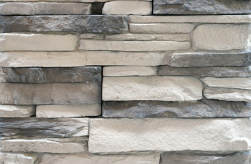 Brick wall with variegated brown bricks. Used as a background.