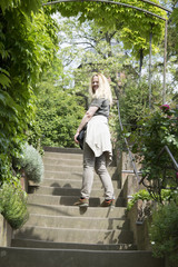 Obraz premium Blond woman goes up the stairs