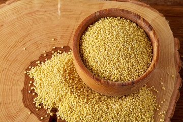 Lentils in a wooden bowl on rustic wooden background, top view, close-up, selective focus.