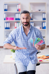 Obraz premium Young designer working in his studio on new project