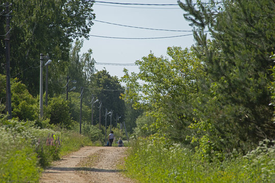  the street of the village in midday sun