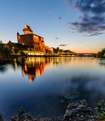 Beautiful night view of Narva Castle with tall Herman's tower, Narva, Estonia
