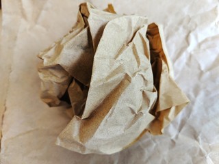 Crumpled brown wax paper wrapper in a ball
