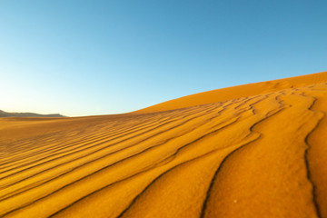 Fototapeta na wymiar Long wind formed ripples with shadow defined edges in dunes of Hidden Vlei, Sossusvlie Namibia