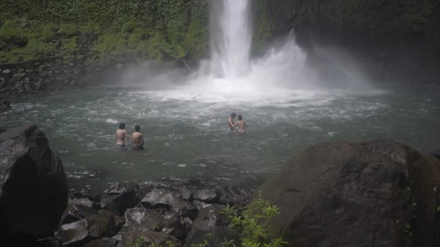Pan Up Kids playing in Waterfall pool, La Fortuna Costa Rica