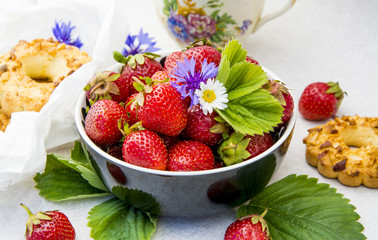 Ripe strawberries and cherries on the kitchen table