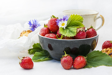 Ripe strawberries and cherries on the kitchen table