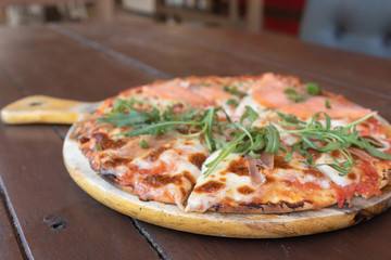 Delicious Baked Italian Salmon Pizza on The Wooden Table