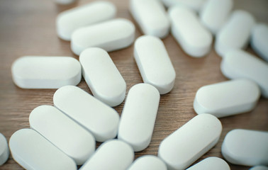 White pills on the table.