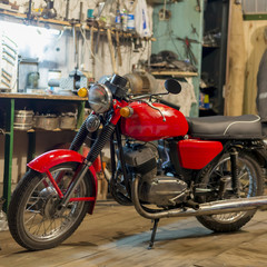 Fototapeta na wymiar Red vintage motorcycle parked in the garage