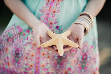 starfish in the hands of a girl