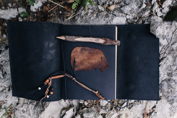 open leather notebook and pencil