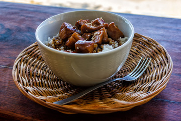 Filipino lunch of rice and omelette with chicken on the beach.